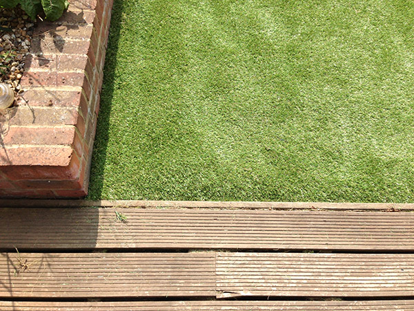 Artificial grass lawn installed in back garden