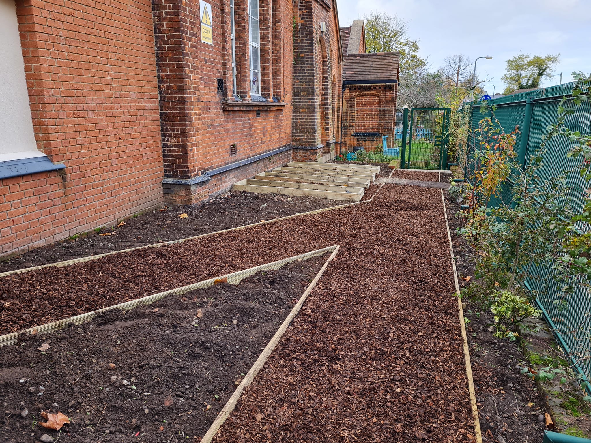 Landscaped beds and timber steps at a school