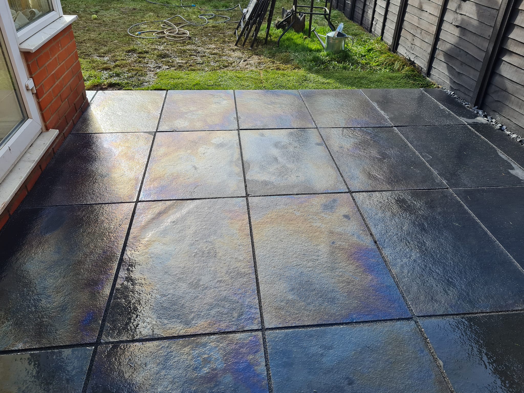 Dark slate patio with a polished wet finish