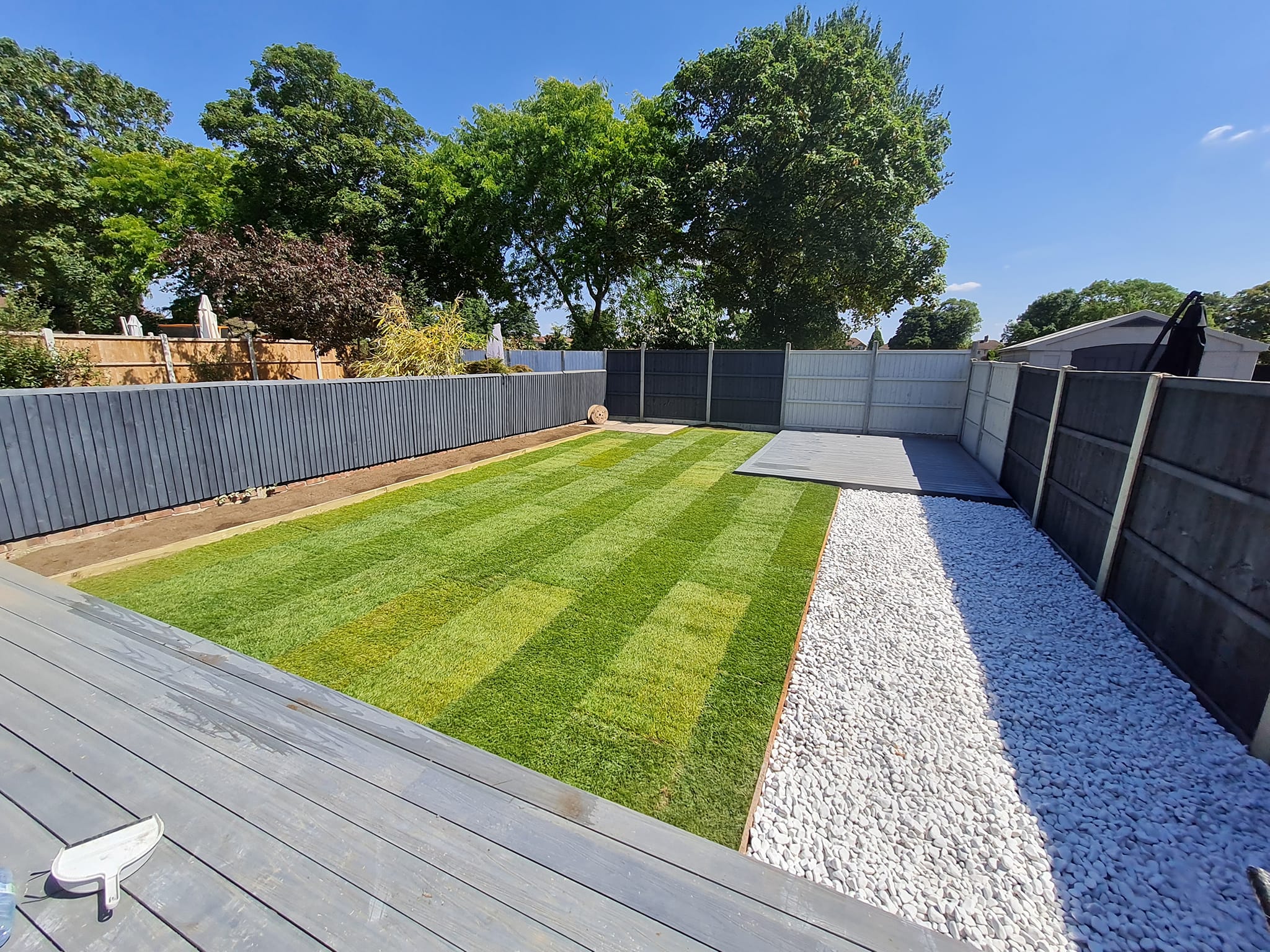 Striped lawn with composite decking and gravel border